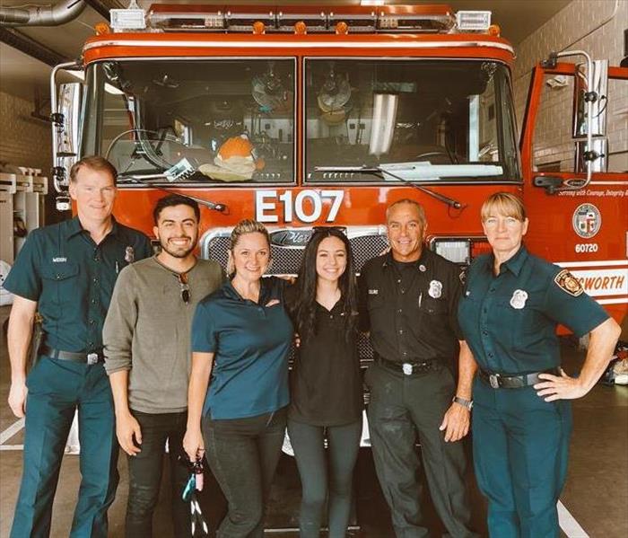 three SERVPRO staff and some local firefighters